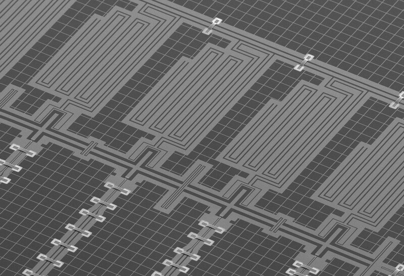 A grayscale scanning-electron-microscope image of superconducting qubits and resonators arranged on a chip.