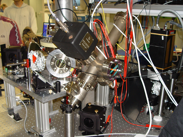 An ion-trap quantum-computing apparatus with optical components and vacuum hardware on a laboratory table in Innsbruck.