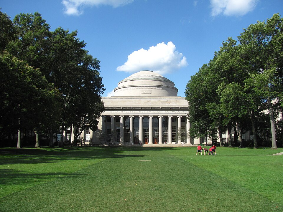 MIT’s Great Dome and columned facade across a green lawn, photographed in 2011.