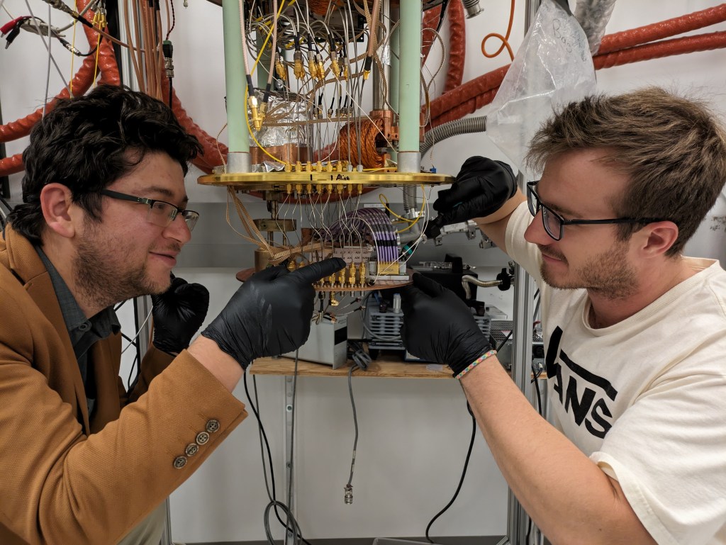 Bakhrom Oripov and Ryan Morgenstern mount a superconducting camera on a cryogenic stage at NIST.