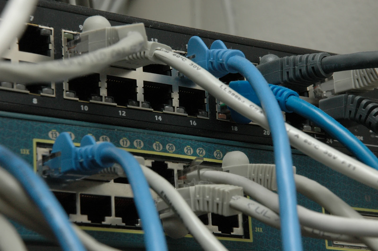 Network switches connected by rows of Ethernet cables.