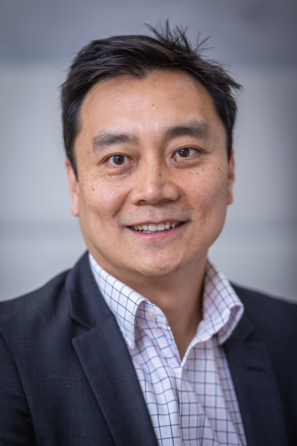 Head-and-shoulders portrait of CSIRO quantum-battery researcher James Quach against a neutral background.