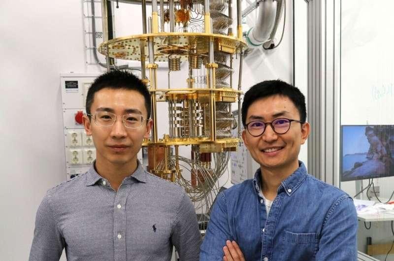 Two Chalmers researchers standing in front of cryogenic quantum-computing equipment.