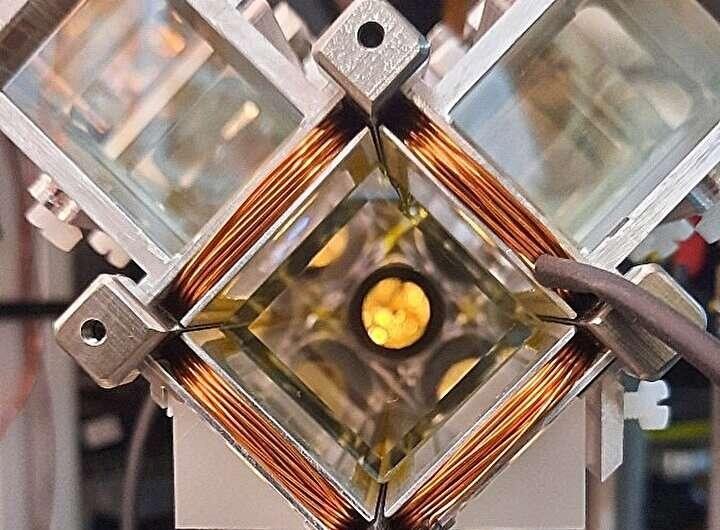 Copper coils and a glass vacuum cell in the cold-atom source of the Quantum Galileo Interferometer.