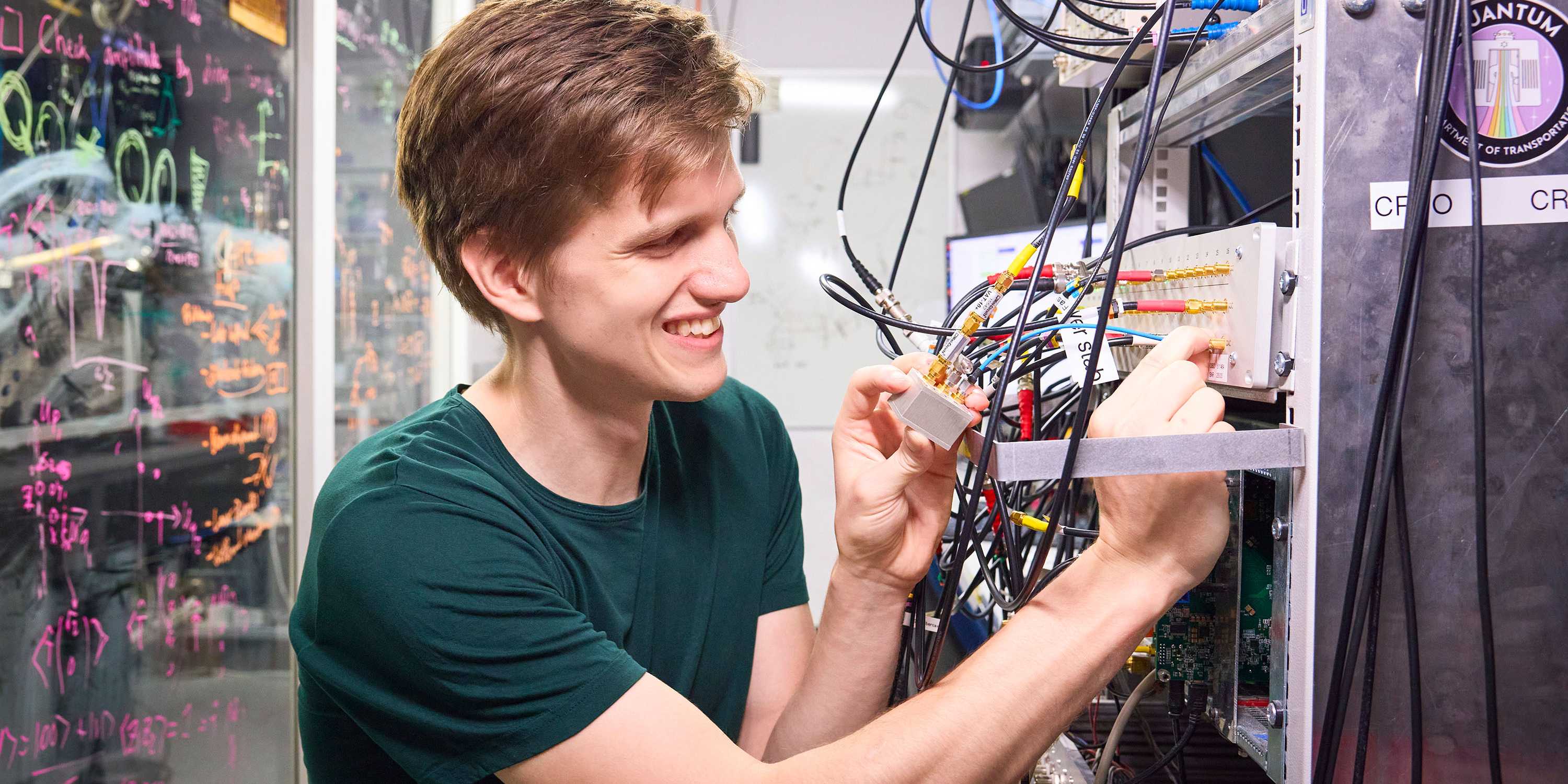 Martin Stadler connects cables to laboratory control hardware at ETH Zurich.