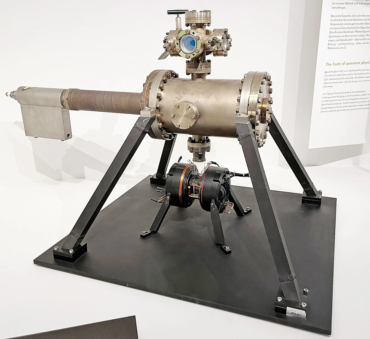 A metal vacuum apparatus on a triangular support frame in a museum display.