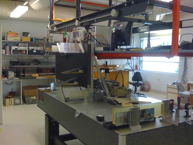 A laboratory workbench holds an optical interferometer and electronic instruments.
