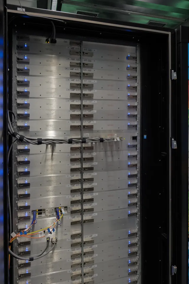 Rows of computing blades sit inside the Cray XC40 Hazel Hen supercomputer.