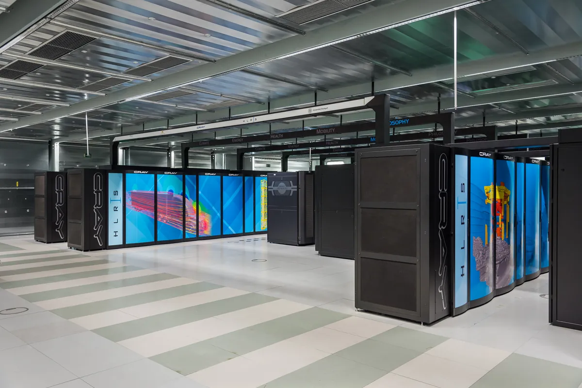 Rows of black Cray cabinets fill a brightly lit supercomputer room.
