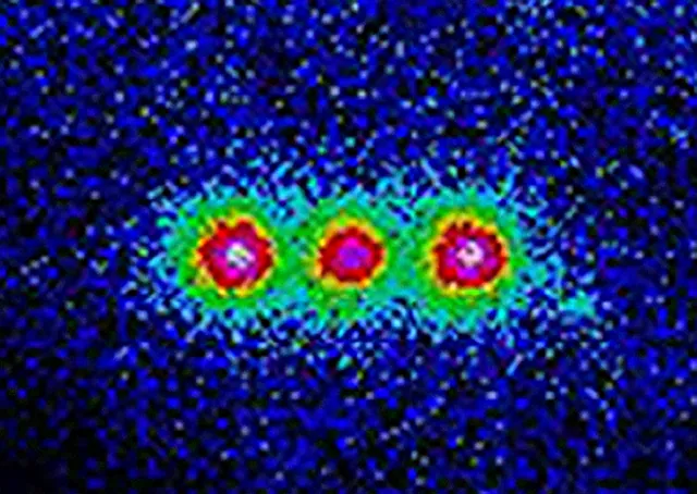 Three bright spots appear in a false-colour fluorescence image of trapped beryllium ions.