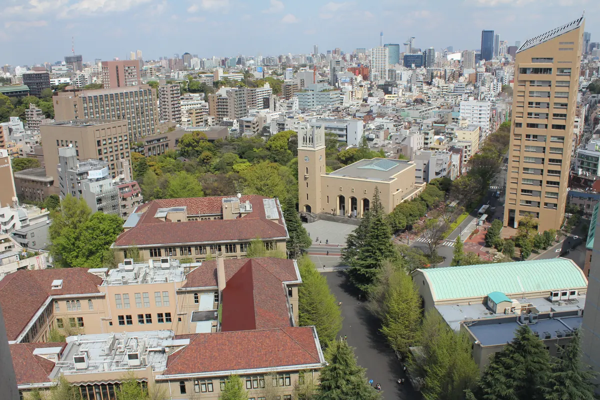 A view across Waseda University’s red-roofed campus buildings and the surrounding city.