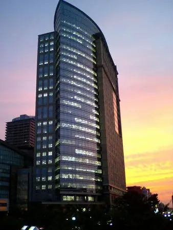 The tall MUZA Kawasaki office tower rising above nearby buildings.