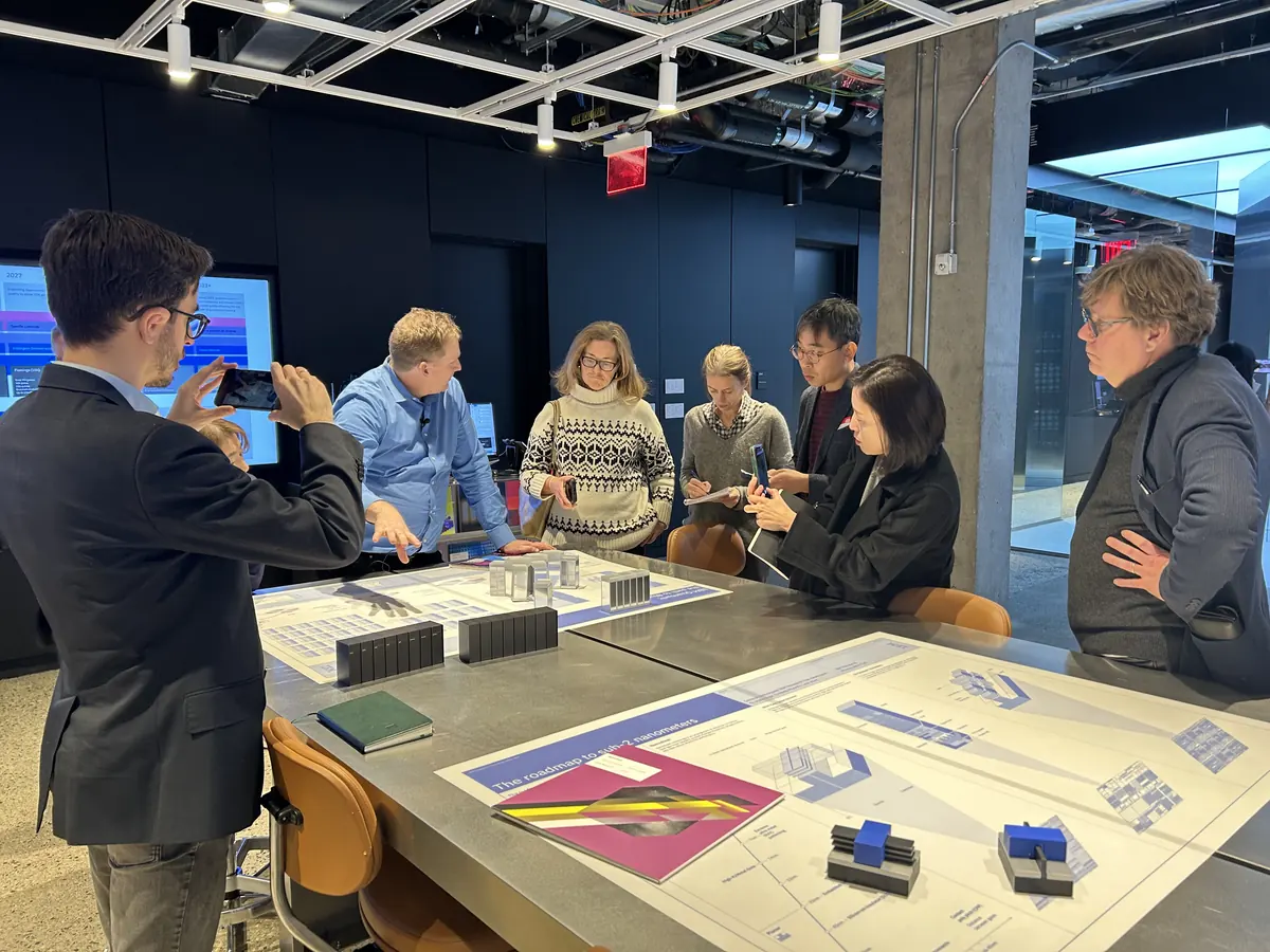 Visitors examining computing hardware during an IBM research-center tour.