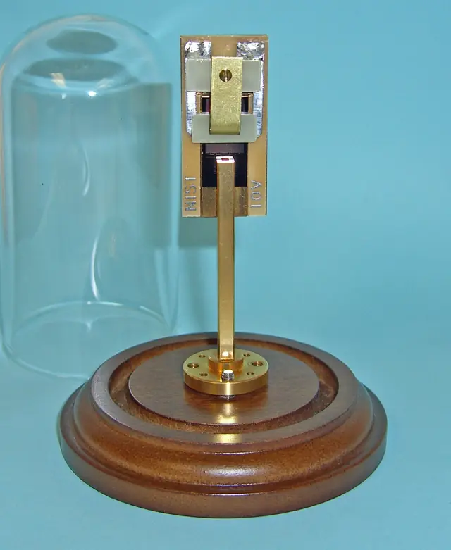 A metal chip holder and microwave waveguide used in an early NIST electrical standard.