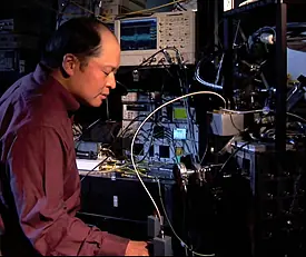 A NIST researcher adjusts refrigeration equipment used to cool single-photon detectors.