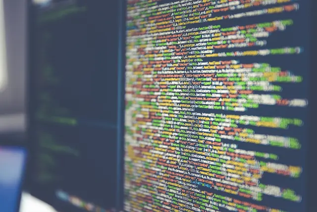 Lines of colored source code displayed on a dark computer screen.