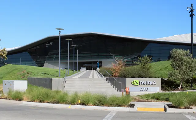 A low NVIDIA office building behind a lawn and trees.