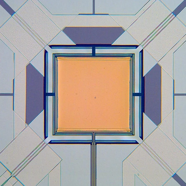 An orange square is surrounded by narrow rectangular borders and fine lines extending toward its corners.