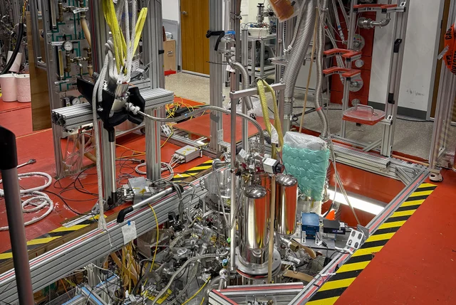 Laboratory apparatus suspended above a floor-level tank at Northwestern University, used to confine a single positron.