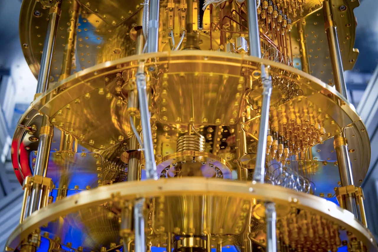 Fine wires descend through several gold-colored plates in IQM cryogenic hardware.