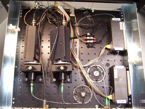 Open instrument enclosure showing optical components, wires and a detector assembly.