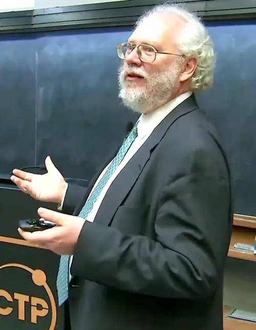 Peter Shor gestures while speaking at the ICTP award ceremony.