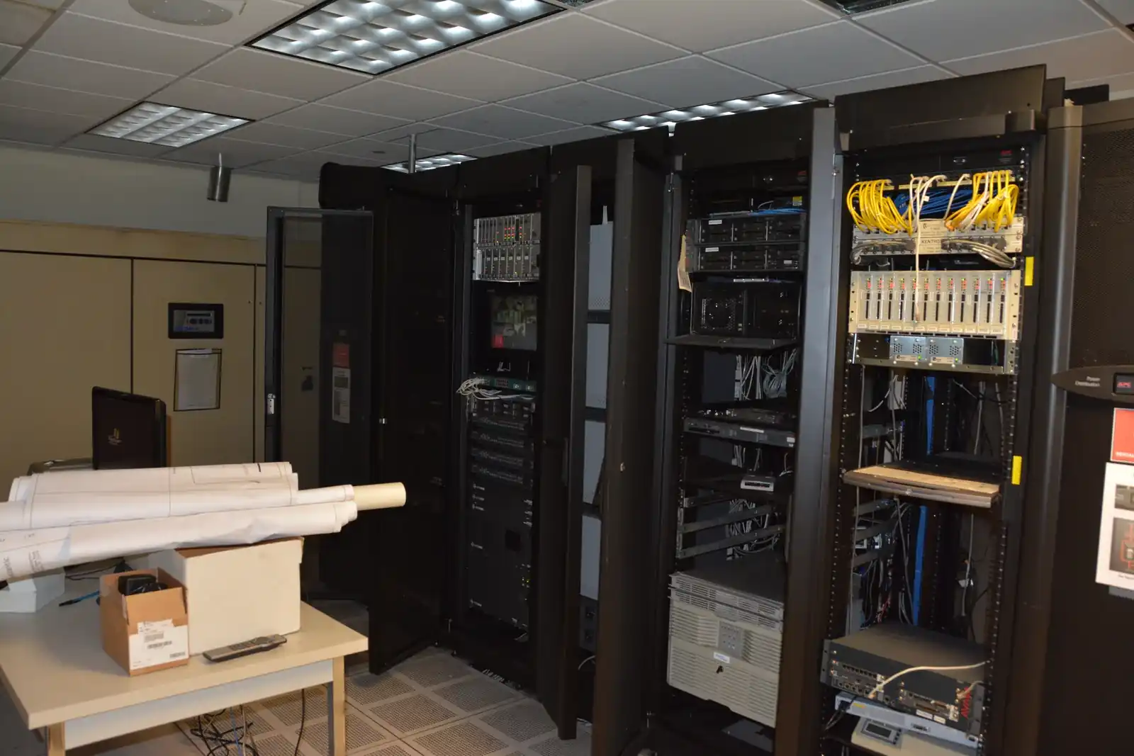 Rows of equipment cabinets in a data center.
