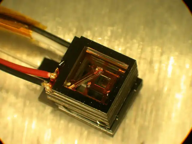 A small NIST magnetic sensor with a rubidium-vapor cell, wires and an optical fiber.