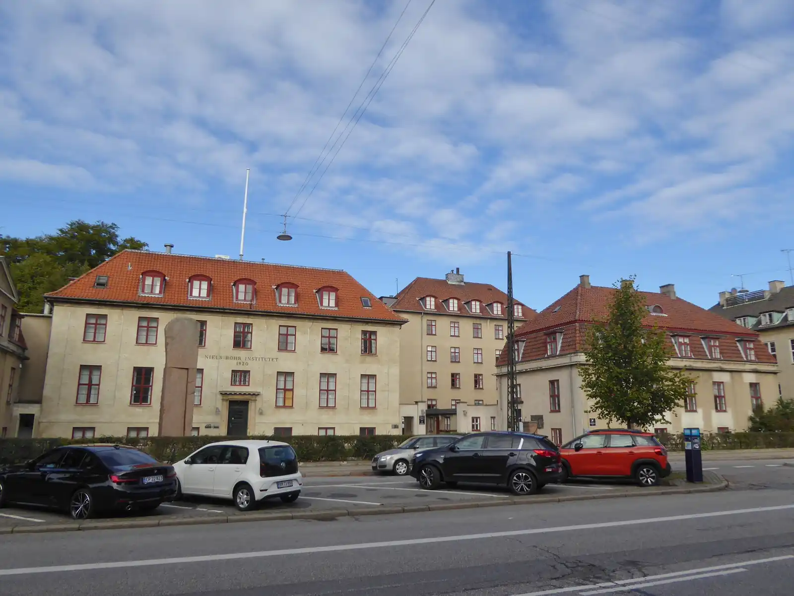 Cream-colored buildings with red tiled roofs at the Niels Bohr Institute on Blegdamsvej in Copenhagen.