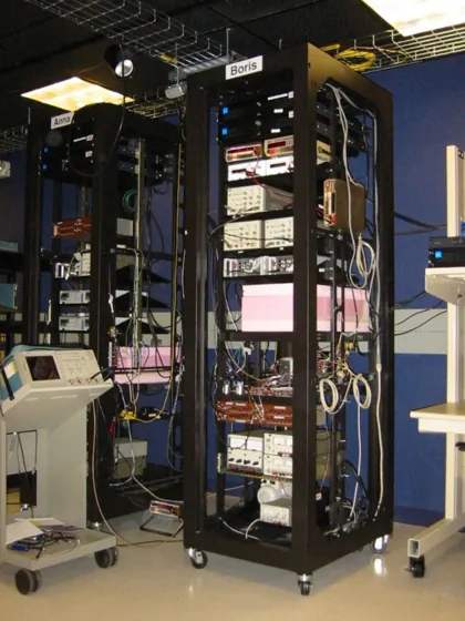 A tall open equipment rack labeled Boris, filled with network instruments and connecting cables.