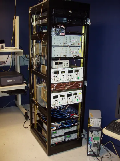 An open rack of instruments and cables forming the historical Barb entangled-link node.