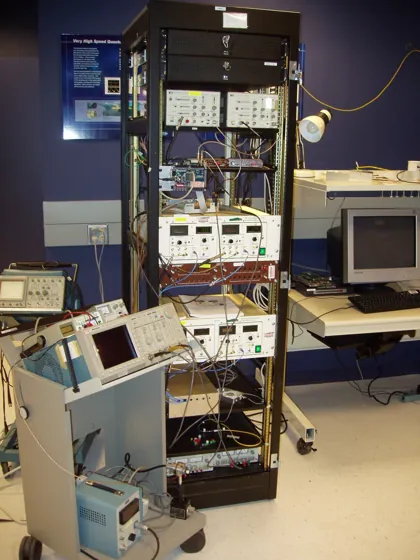 An instrument rack with connected electronics forming the historical Alex entangled-link node.
