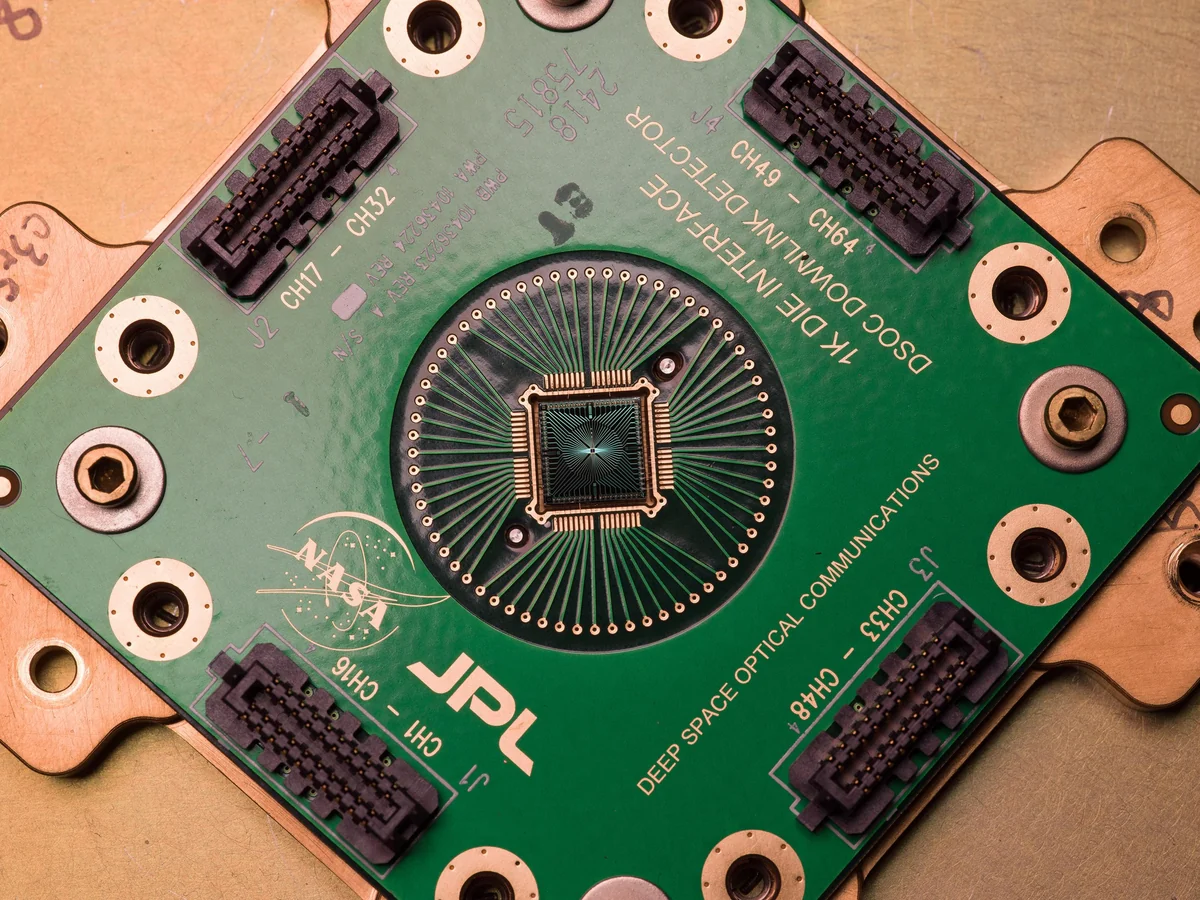 A detector chip at the center of a green DSOC circuit board with connectors and NASA/JPL markings.